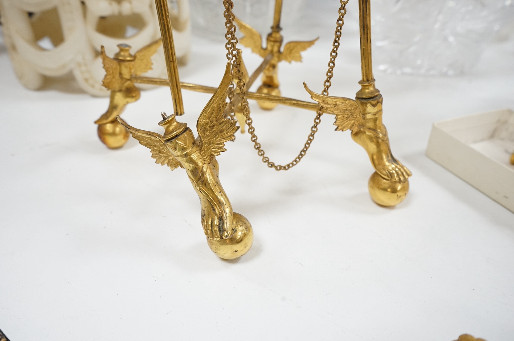 An unusual enamel and gilt brass timepiece, pendant from gilt brass frame, stand 26cm high. Condition - dismantled
